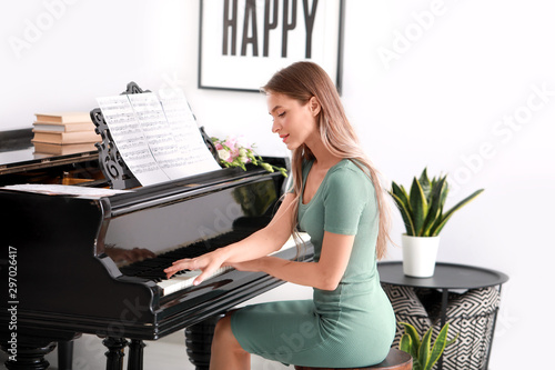 Young woman playing grand p...