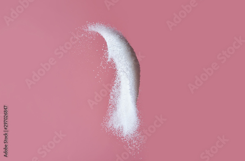 Throwing of sand sugar against color background photo