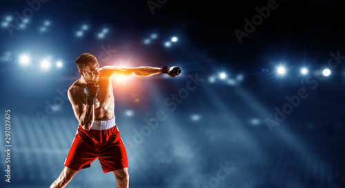 Professional boxer punchon dark arena © Sergey Nivens