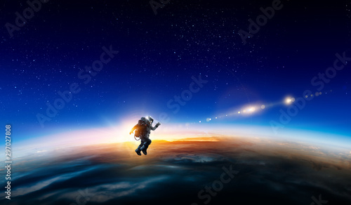 Spaceman and planet, human in space concept © Sergey Nivens