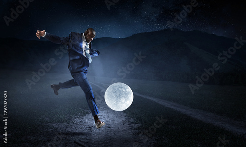 Black businessman plays football with Moon