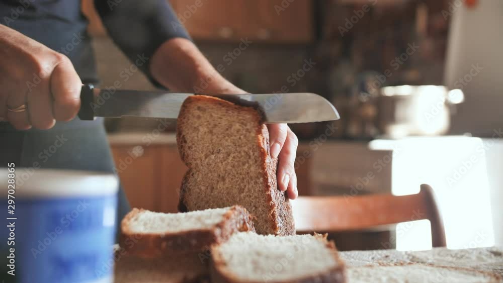 Cooking breakfast. A young woman cuts bread. Cooking breakfast. A young woman cuts bread.