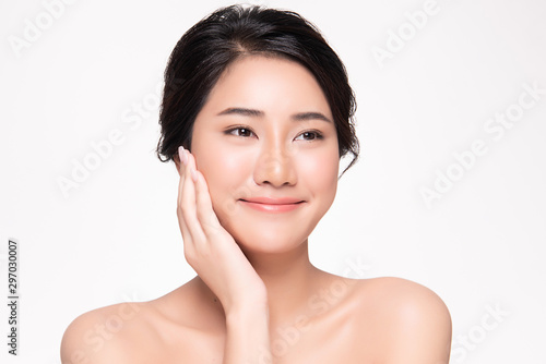 Beautiful Asian young woman touching soft cheek and smile with clean and fresh skin. Happiness and cheerful with, isolated on white background, Beauty and Cosmetics Concept