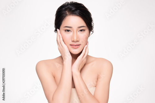 Beautiful Asian young woman touching soft cheek and smile with clean and fresh skin. Happiness and cheerful with, isolated on white background, Beauty and Cosmetics Concept