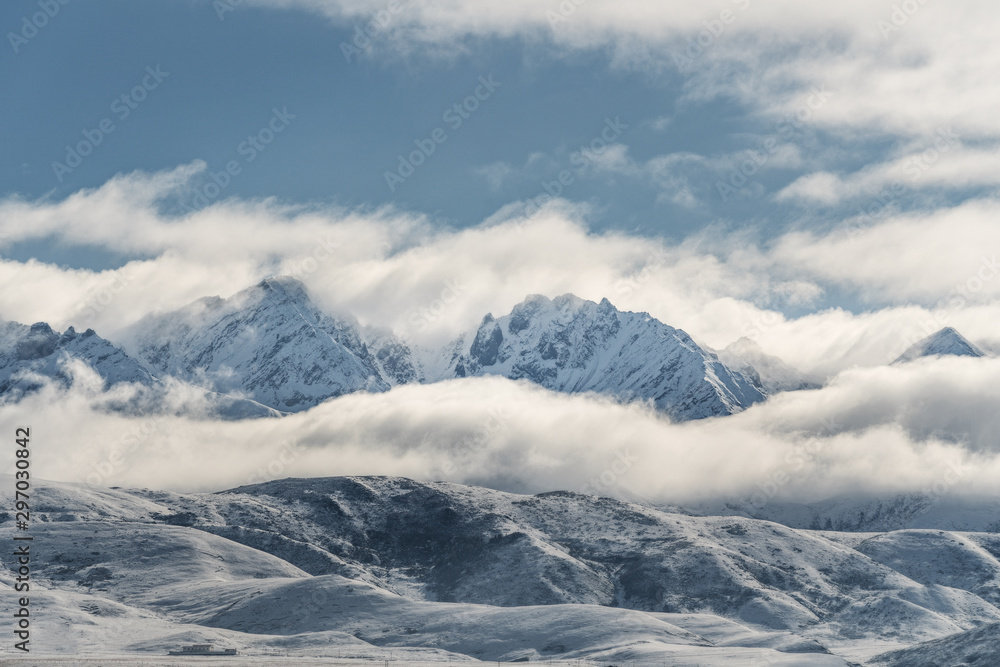 Panoramic snow mountain with white clouds and blue sky	