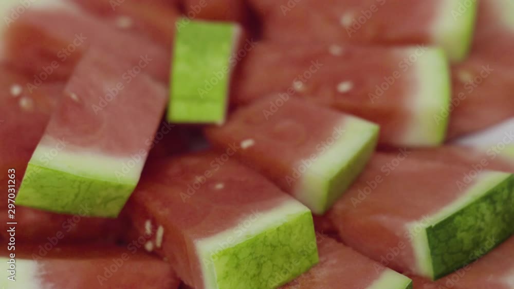 Small slices of red seedless watermelon on the tray for the party. Small slices of red seedless watermelon on the tray for the party.