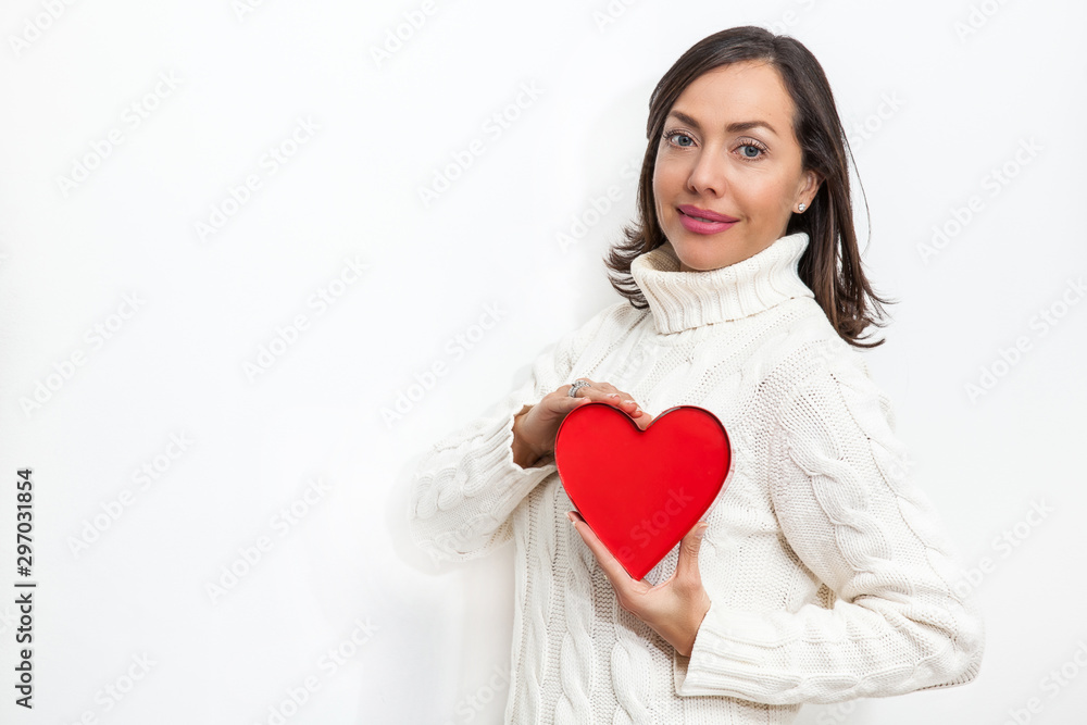 Happy beautiful woman holding a red heart on her hands isolated on white background. Conceptual for love, healthcare, cardiology. Happy beautiful woman holding a red heart on her hands isolated on white background. Conceptual for love, healthcare, cardiology.