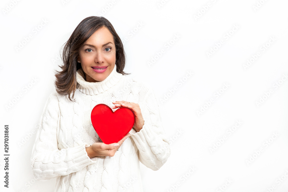 Happy beautiful woman holding a red heart on her hands isolated on white background. Conceptual for love, healthcare, cardiology. Happy beautiful woman holding a red heart on her hands isolated on white background. Conceptual for love, healthcare, cardiology.