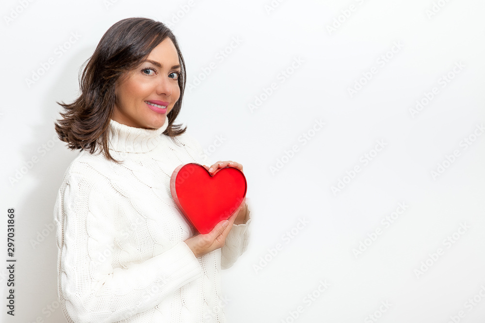 Happy beautiful woman holding a red heart on her hands isolated on white background. Conceptual for love, healthcare, cardiology. Happy beautiful woman holding a red heart on her hands isolated on white background. Conceptual for love, healthcare, cardiology.