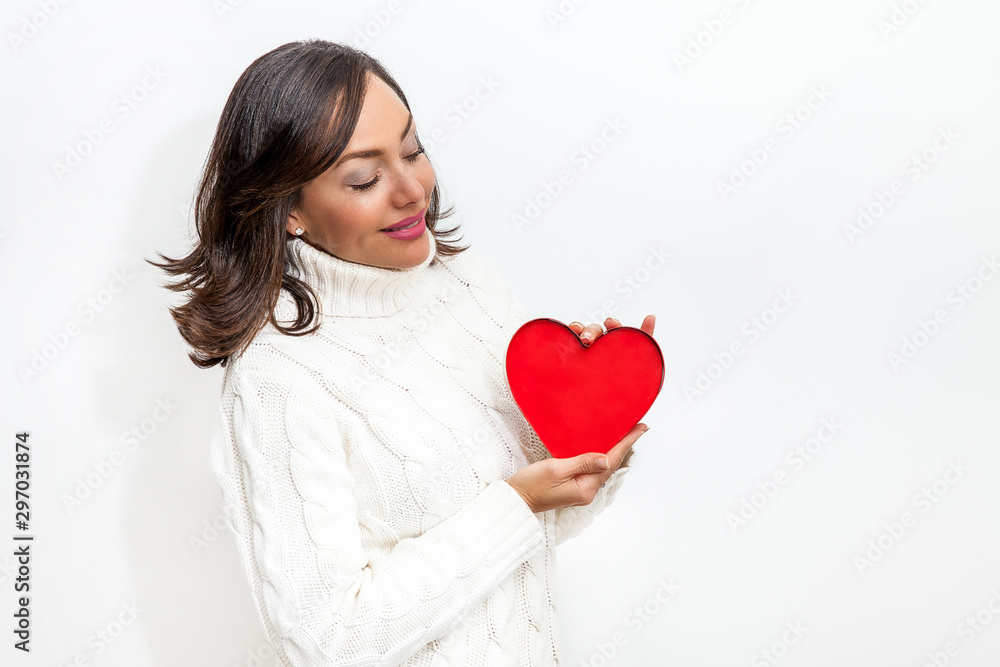 Happy beautiful woman holding a red heart on her hands isolated on white background. Conceptual for love, healthcare, cardiology. Happy beautiful woman holding a red heart on her hands isolated on white background. Conceptual for love, healthcare, cardiology.