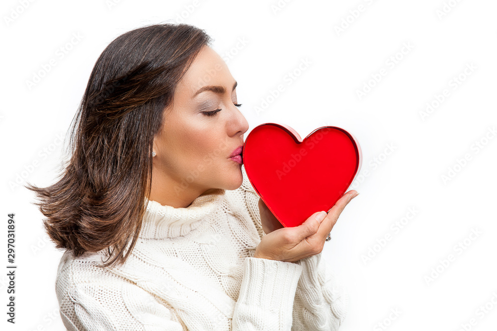 Happy beautiful woman holding a red heart on her hands isolated on white background. Conceptual for love, healthcare, cardiology Happy beautiful woman holding a red heart on her hands isolated on white background. Conceptual for love, healthcare, cardiology