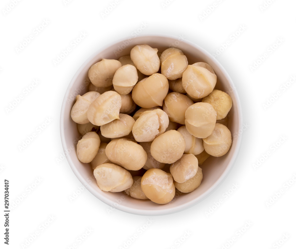 shelled macadamia fruit in the white bowl isolated on white background, flat lay, top view shelled macadamia fruit in the white bowl isolated on white background, flat lay, top view