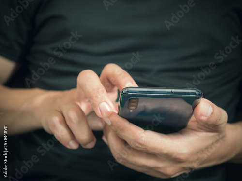 Closeup male hands using smartphone