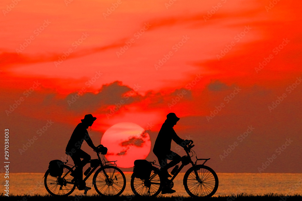 silhouette happy family  and bike  on sunrise