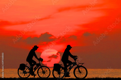 silhouette happy family and bike on sunrise