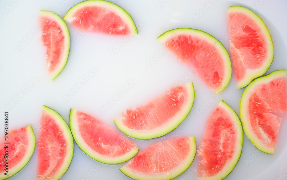 Turbid soapy water in bath with slices of watermelon. top view in full frame. The largest berry. spa with milk in the bath for rejuvenation.. Turbid soapy water in bath with slices of watermelon. top view in full frame. The largest berry. spa with milk in the bath for rejuvenation..