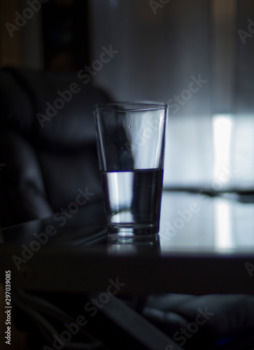 half empty glass in an empty room esoteric