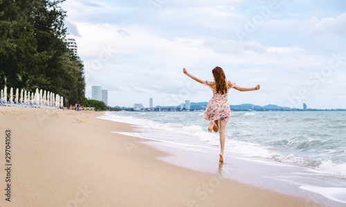 Travel woman walking on beach