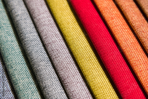 Colorful and bright fabric samples of furniture and clothing upholstery. Close-up of a palette of textile abstract diagonal stripes of different colors photo