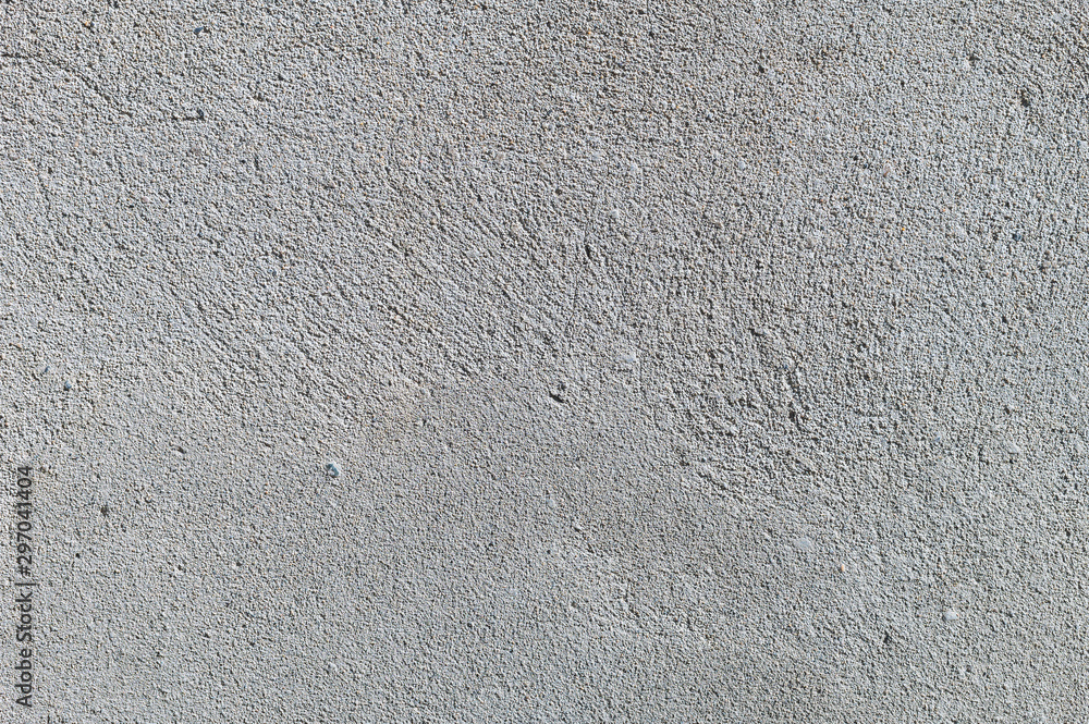 Gray textured cement wall background with fine concrete chips. Construction backgrounds Gray textured cement wall background with fine concrete chips. Construction backgrounds