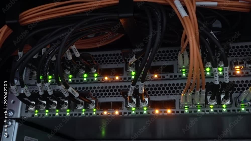 Orange and green lamps. The back of a large optical server. Camera in motion Orange and green lamps. The back of a large optical server. Camera in motion