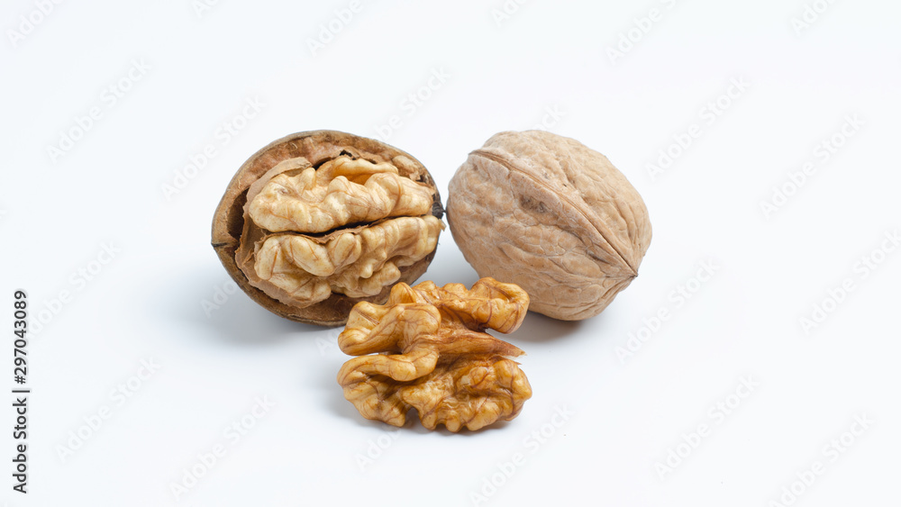 Three walnuts lying in a handful, a closed nut, half peeled walnut and half a walnut. Three walnuts lying in a handful, a closed nut, half peeled walnut and half a walnut.