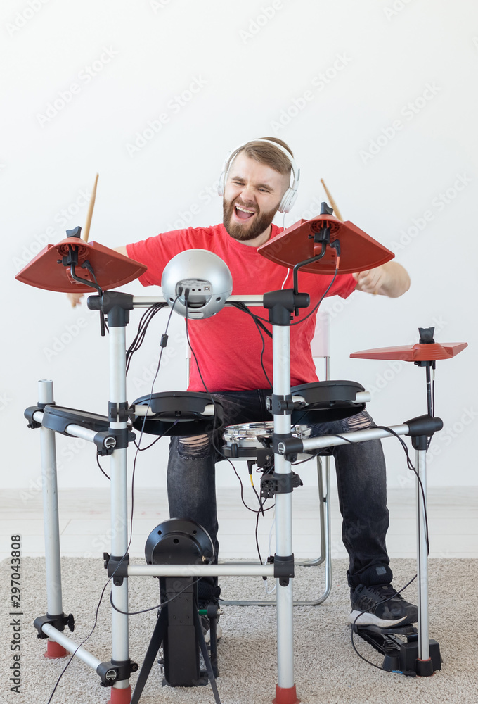 Fototapeta premium People, free time and hobby concept - bearded man drummer playing the drum.