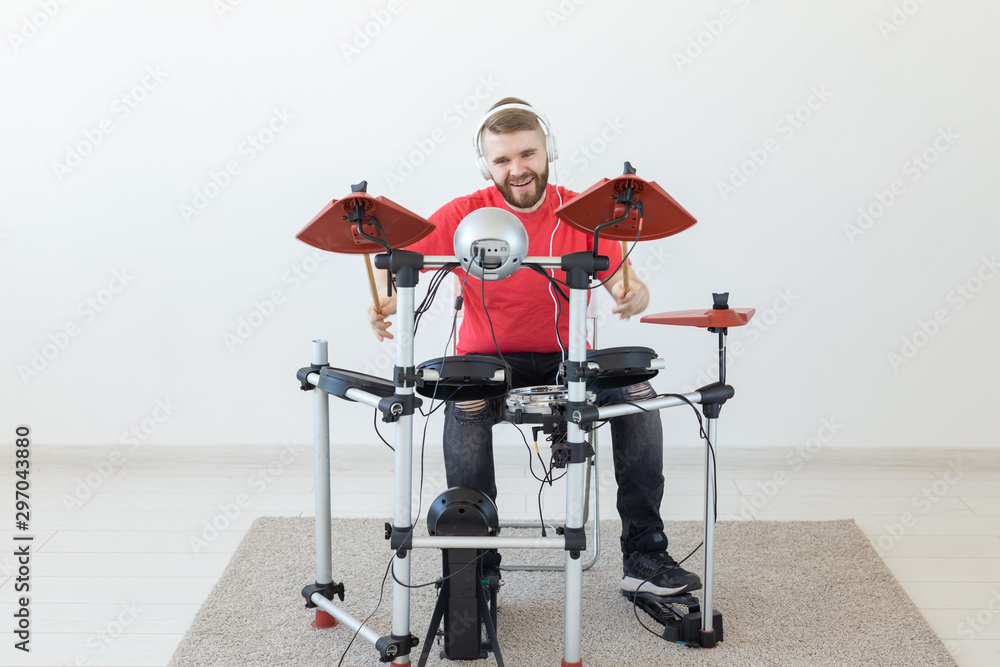 People, music and hobby concept - Man in his spare time playing the electronic drum set People, music and hobby concept - Man in his spare time playing the electronic drum set