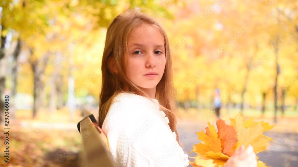 teenage girl having rest among maple trees in autumn park teenage girl having rest among maple trees in autumn park