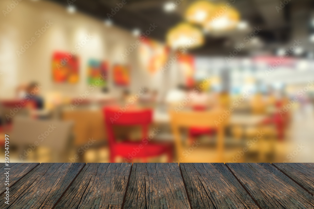 Defocus inside of restaurant with wood table at foreground.