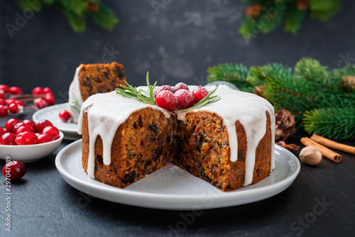 Traditional Christmas fruit cake, pudding with dried fruits, nuts and white glaze.
