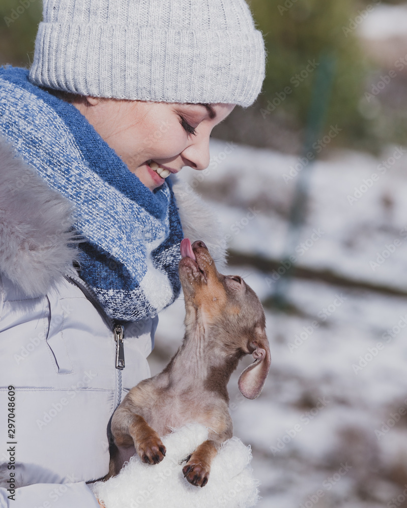 Woman playing with dog during winter Woman playing with dog during winter