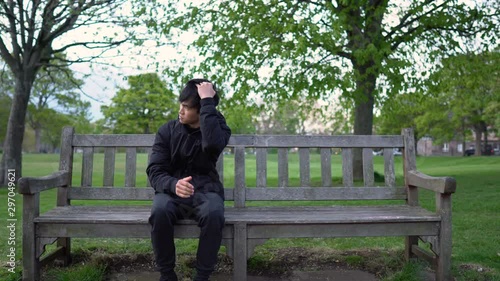 Nervous 20s Asian Man Waiting For Date in Park - Social Anxiety photo