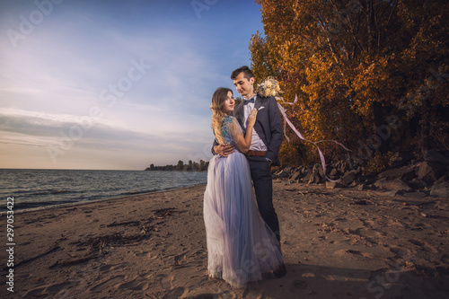 Wallpaper Mural happy bride and groom are walking on the autumn beach Torontodigital.ca