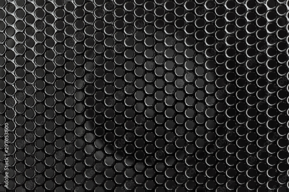 Black metal grid on audio speaker. Audio speaker texture. Macrophoto. Abstract background. Black metal grid on audio speaker. Audio speaker texture. Macrophoto. Abstract background.