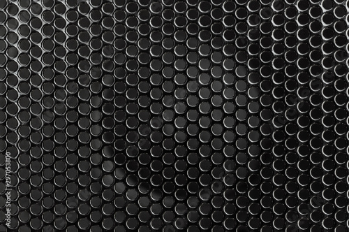 Black metal grid on audio speaker. Audio speaker texture. Macrophoto. Abstract background.