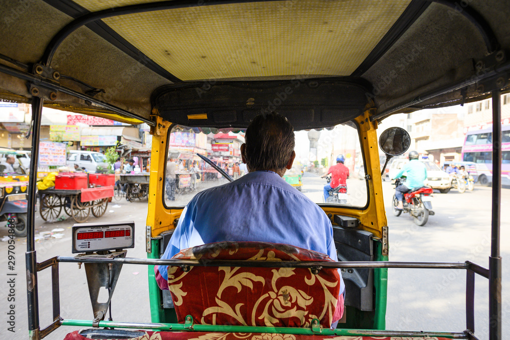 (Passenger point of view) A unidentified driver is riding his auto rickshaw (also known as Tuc Tuc) through the busy streets of the pink city of Jaipur, Rajasthan, India.