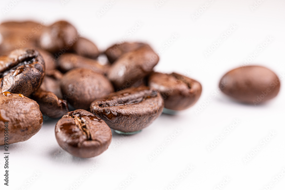 Macro view of roasted coffee beans on white background Macro view of roasted coffee beans on white background