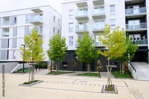 Sidewalk in a cozy courtyard of modern apartment buildings condo with white walls. photo