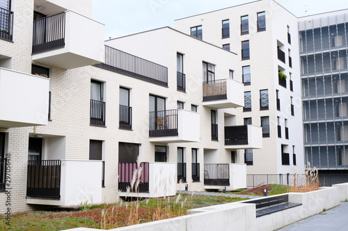 Cozy courtyard of modern apartment buildings district with white walls.