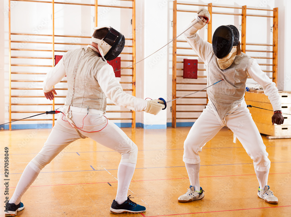 fencers at fencing workout, practicing attack movements