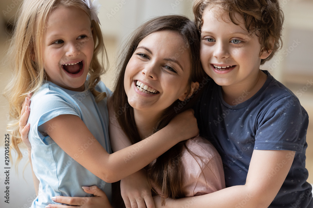 Head shot happy mother having fun with son and daughter Head shot happy mother having fun with son and daughter