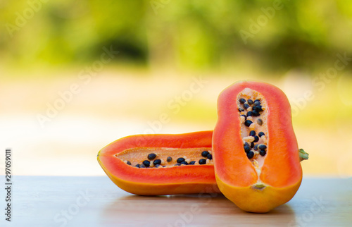 Healthy papaya, food and fruit placed on a wooden table in the warm natural morning.