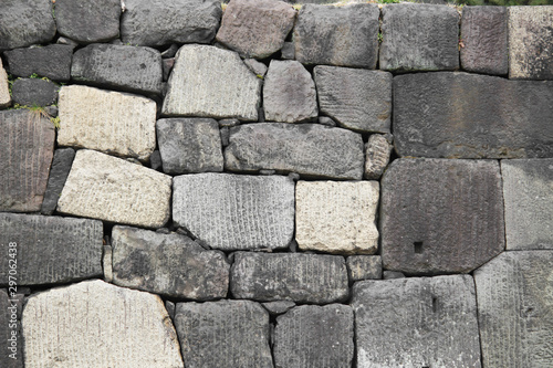 Photo of a wall of white stones stacked as background material