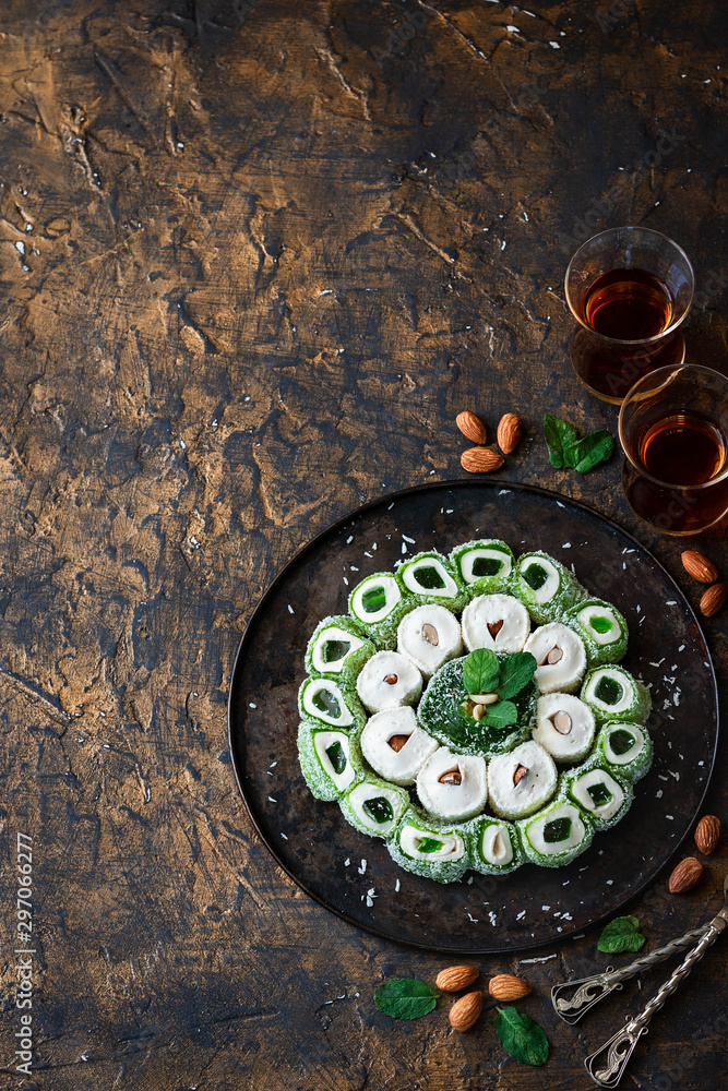 Turkish Delight. Assorted oriental sweets with nuts on a dark background.