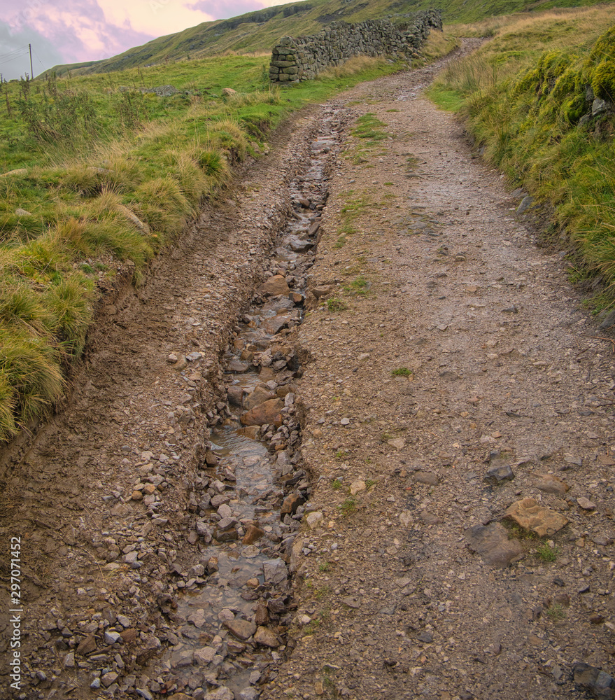 A footpath in Nidderdale, Yorkshire, UK showing serious erosion damage by rainfall water. A footpath in Nidderdale, Yorkshire, UK showing serious erosion damage by rainfall water.