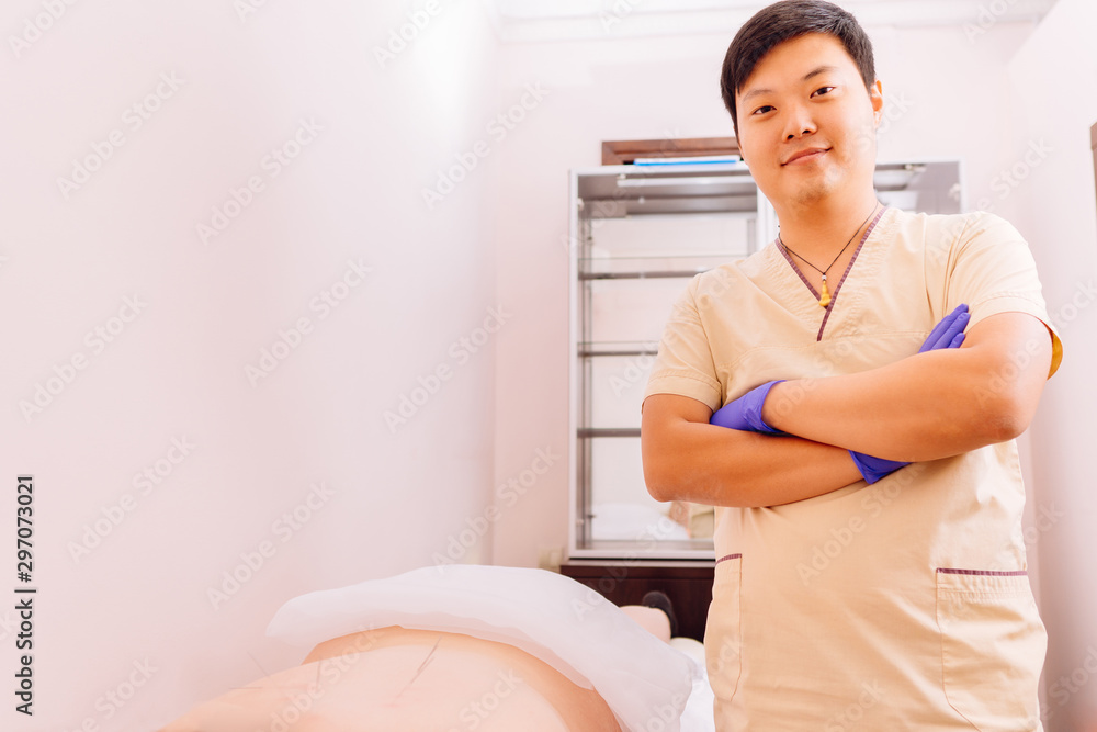 Fototapeta premium Young woman undergoing acupuncture treatment. Traditional Chinese treatment, alternative medicine