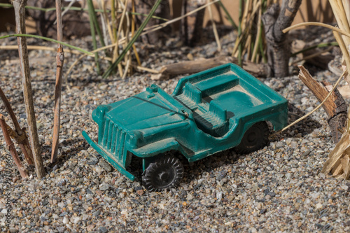 plastic toy car, plastic toy car in combat field, plastic toy, small toy, small toy combat car