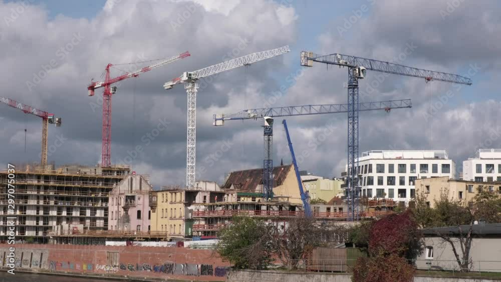 Many high tower cranes work on the construction of new buildings. Many high tower cranes work on the construction of new buildings.