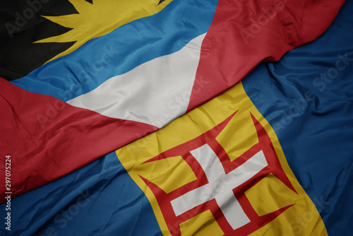 waving colorful flag of madeira and national flag of antigua and barbuda.